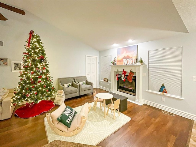 living room with lofted ceiling and hardwood / wood-style flooring