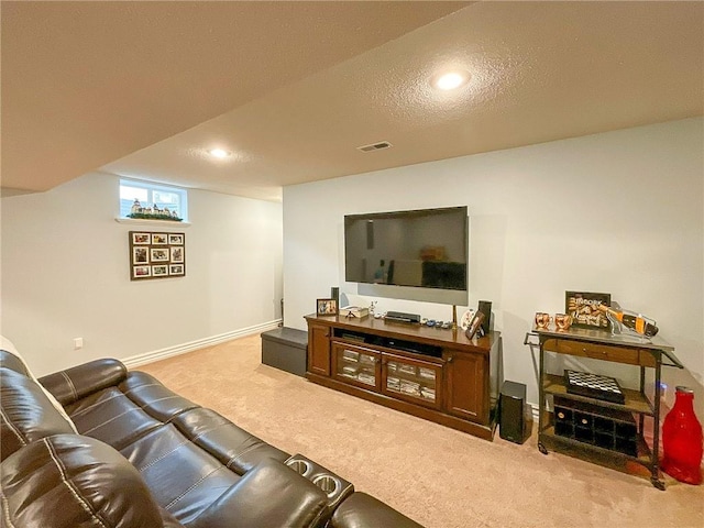 carpeted living room featuring a textured ceiling