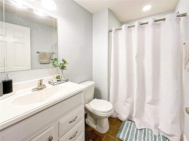 bathroom featuring a shower with curtain, tile patterned flooring, vanity, and toilet