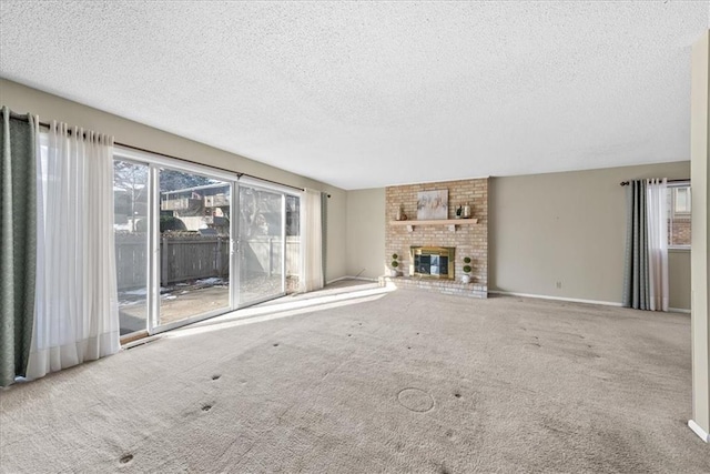 unfurnished living room with a fireplace, a textured ceiling, and carpet