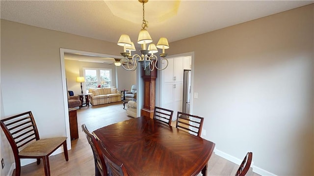 dining space with a chandelier and light hardwood / wood-style flooring