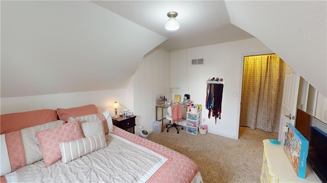 bedroom with lofted ceiling and carpet flooring