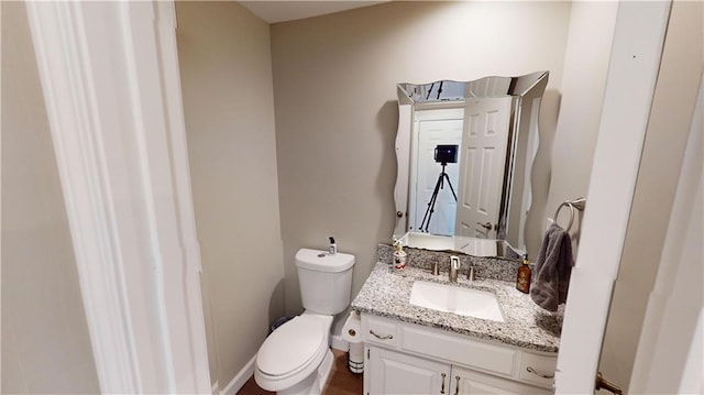 bathroom with toilet and vanity