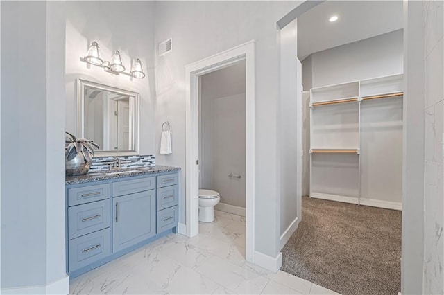 bathroom featuring vanity and toilet