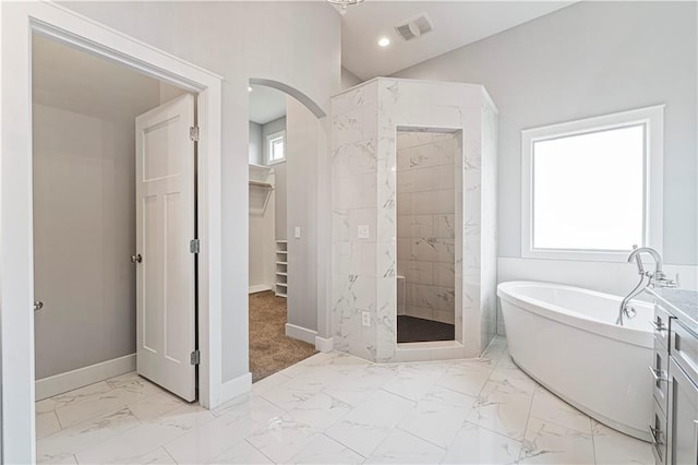 bathroom with vanity and separate shower and tub