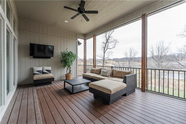 deck with an outdoor living space and ceiling fan