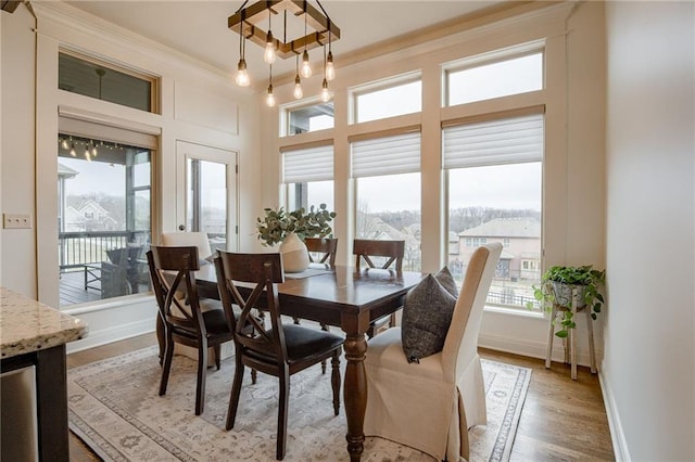 dining space featuring light hardwood / wood-style flooring and ornamental molding