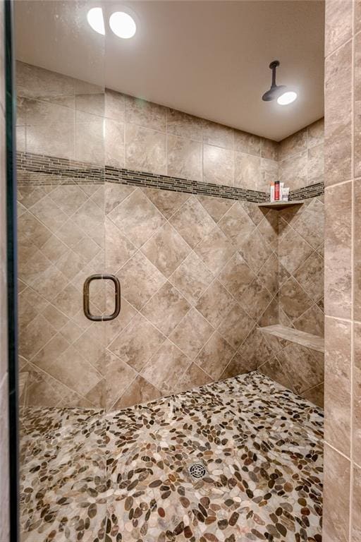 bathroom featuring a shower with door