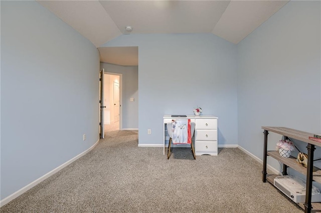 home office with lofted ceiling and carpet floors