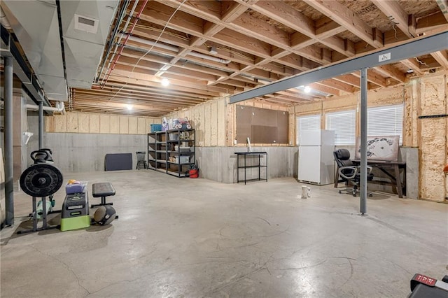 basement with white refrigerator