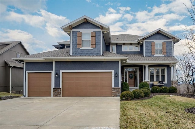 craftsman-style home with a garage and a front lawn