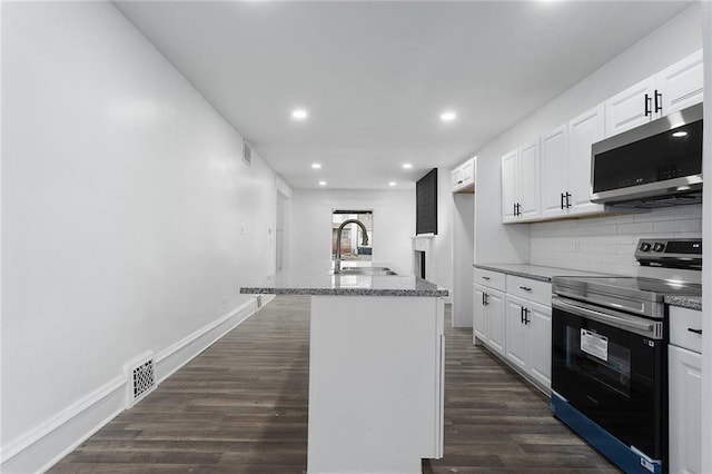 kitchen with white cabinetry, an island with sink, and appliances with stainless steel finishes