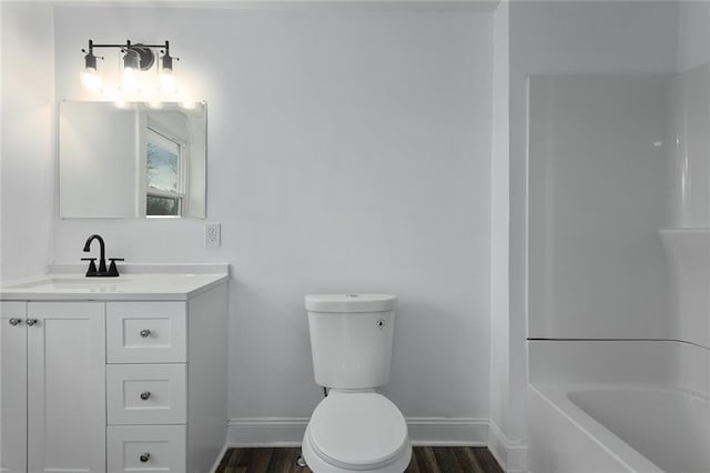 full bathroom featuring hardwood / wood-style flooring, vanity, bathtub / shower combination, and toilet