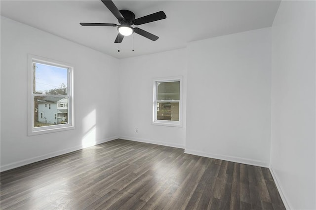 unfurnished room featuring ceiling fan and dark hardwood / wood-style flooring