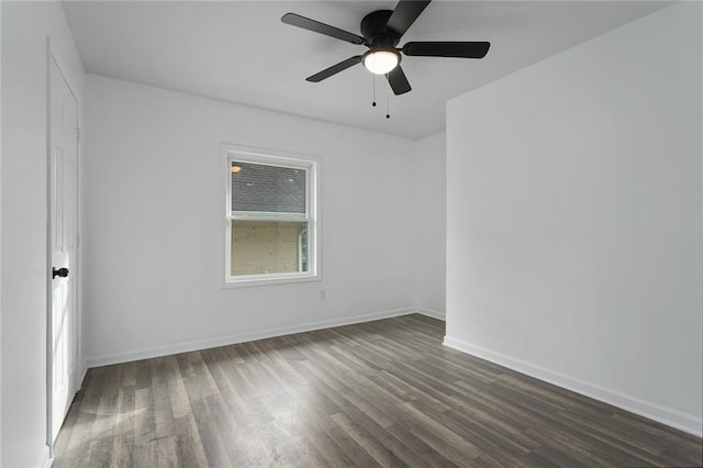 empty room with dark hardwood / wood-style floors and ceiling fan