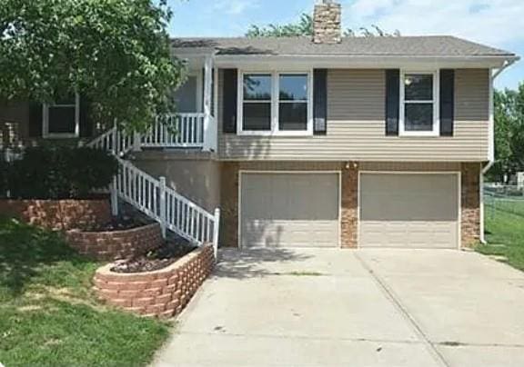 view of front of house with a garage and a front lawn