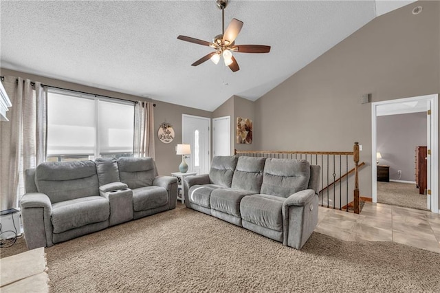 carpeted living room featuring ceiling fan, lofted ceiling, and a textured ceiling