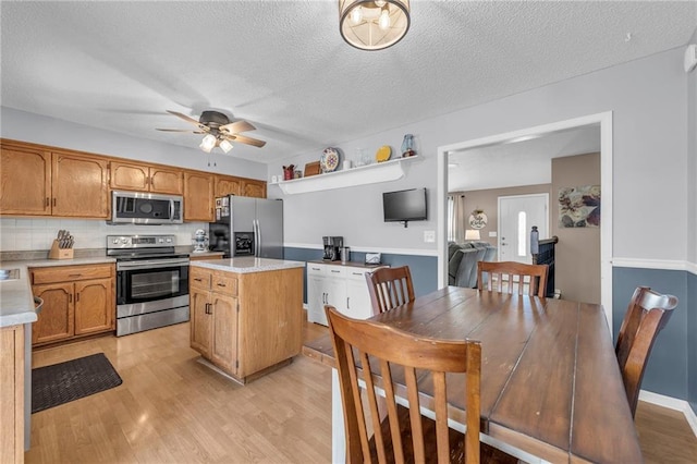 kitchen with backsplash, a center island, stainless steel appliances, and a textured ceiling