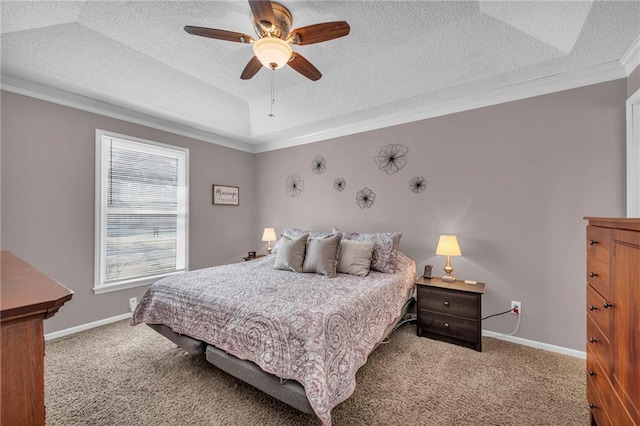 bedroom with carpet flooring, a textured ceiling, a tray ceiling, and ceiling fan