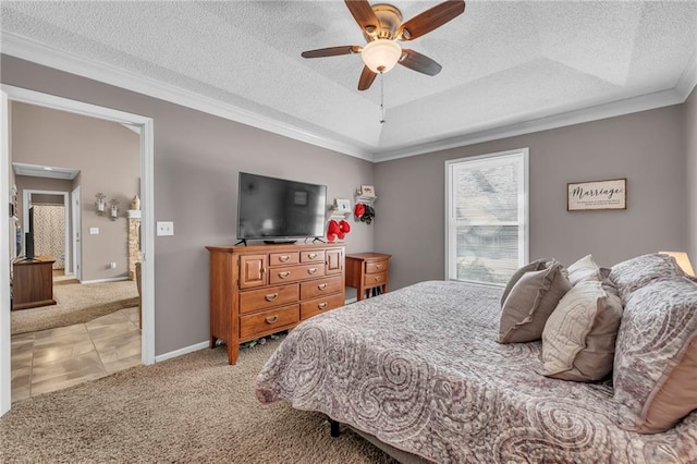 bedroom featuring carpet, a textured ceiling, a tray ceiling, ceiling fan, and crown molding