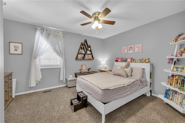 bedroom featuring carpet, ceiling fan, and a textured ceiling