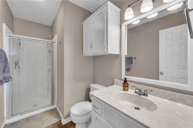 bathroom featuring a textured ceiling, vanity, toilet, and walk in shower