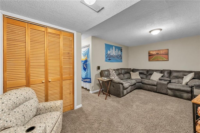 living room featuring a textured ceiling and carpet floors