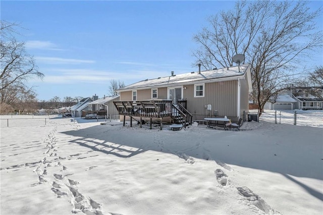 snow covered property featuring a deck