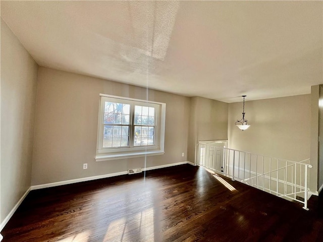 unfurnished room with dark hardwood / wood-style floors