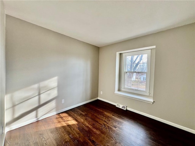 unfurnished room featuring dark hardwood / wood-style floors