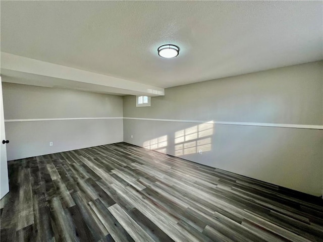 interior space featuring a textured ceiling and dark hardwood / wood-style floors