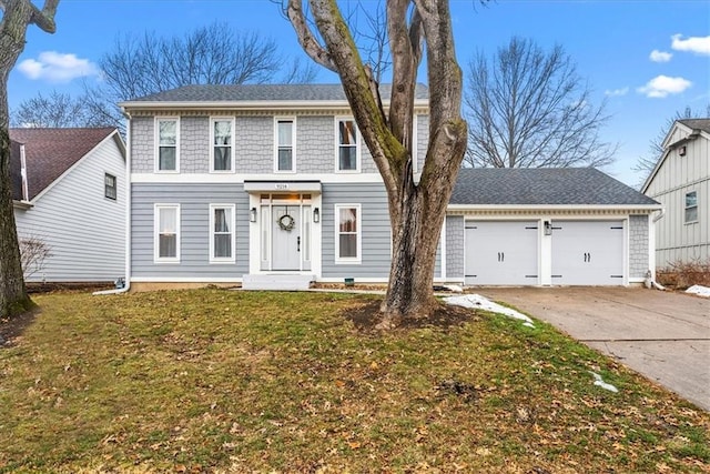 view of front of house featuring a garage and a front lawn