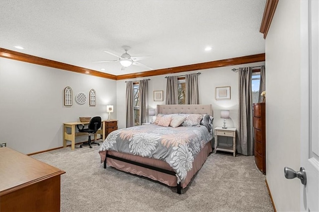 carpeted bedroom featuring a textured ceiling, ornamental molding, and ceiling fan