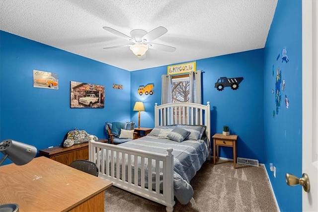 bedroom featuring ceiling fan, dark carpet, and a textured ceiling