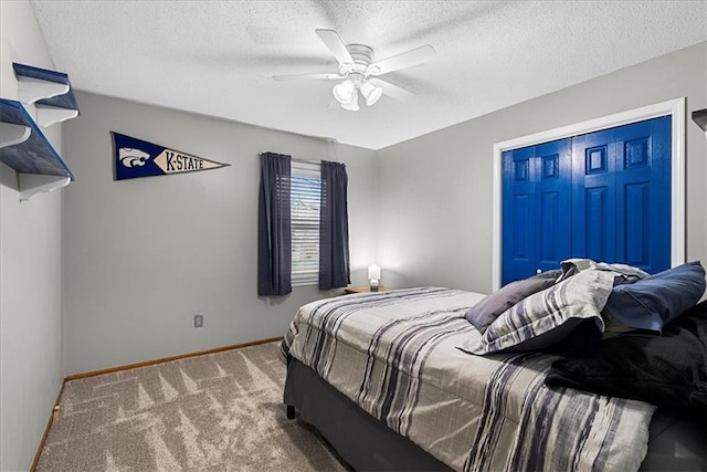 bedroom featuring ceiling fan, carpet flooring, and a textured ceiling