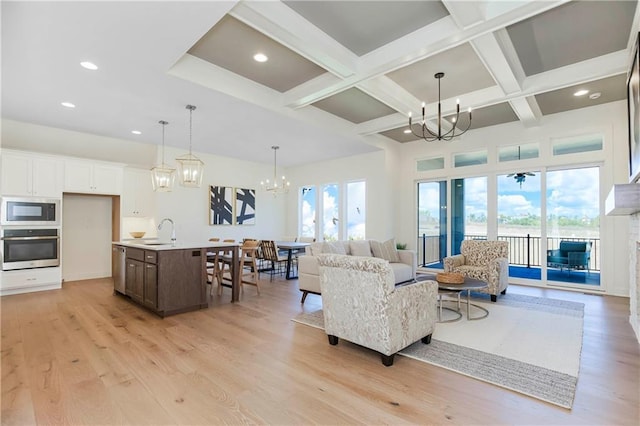 4218 W 158th Ter, Overland Park, KS 66224 - living room featuring a chandelier, recessed lighting, beamed ceiling, coffered ceiling, and light wood-style flooring