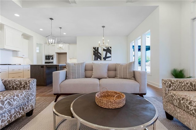 4218 W 158th Ter, Overland Park, KS 66224 - living room with wood finished floors, a chandelier, and recessed lighting