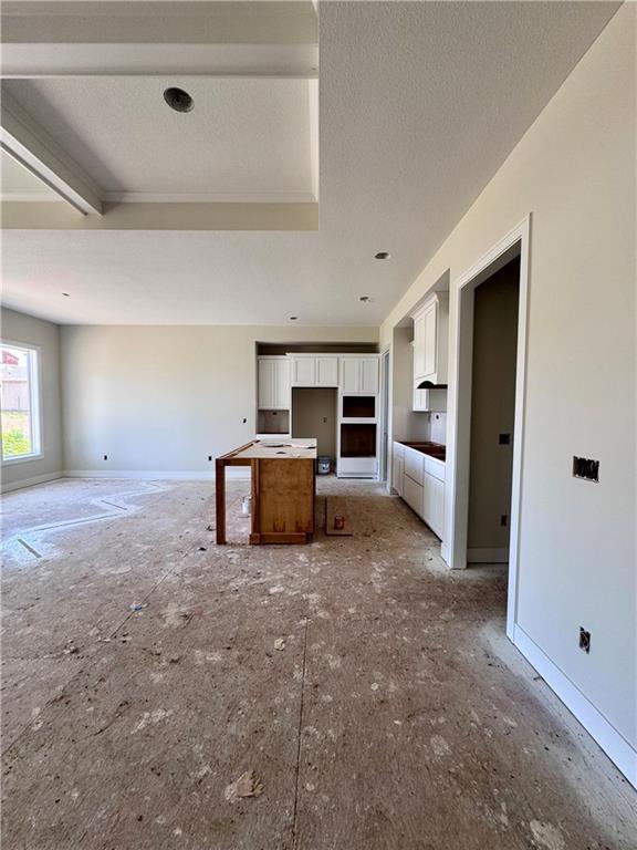 4218 W 158th Ter, Overland Park, KS 66224 - kitchen featuring white cabinets, open floor plan, and a textured ceiling