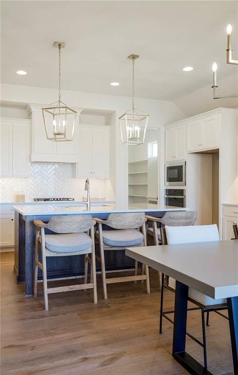4218 W 158th Ter, Overland Park, KS 66224 - kitchen with appliances with stainless steel finishes, white cabinets, backsplash, dark wood-style flooring, and light countertops