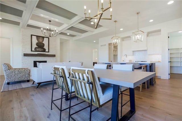 4218 W 158th Ter, Overland Park, KS 66224 - dining area with a chandelier, wood finished floors, recessed lighting, beam ceiling, and coffered ceiling