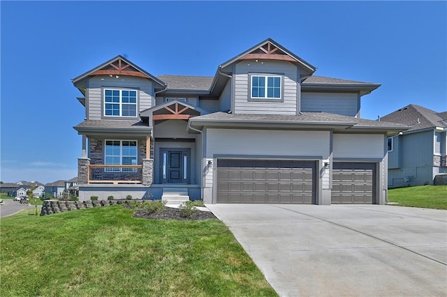 view of front of home featuring a garage and a front lawn