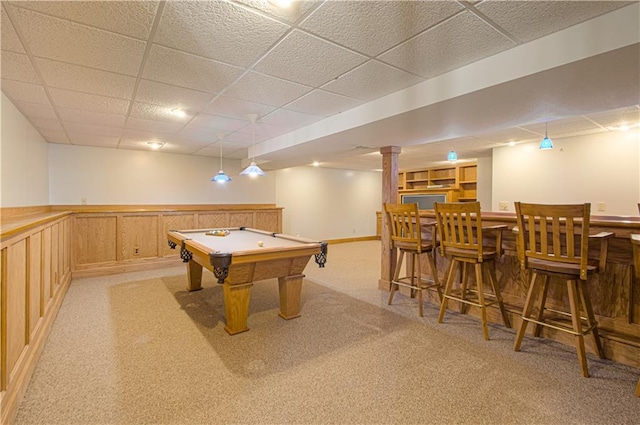 playroom with pool table, indoor bar, light colored carpet, and a paneled ceiling