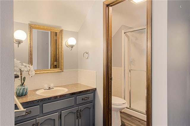 bathroom with toilet, a shower with door, vanity, and hardwood / wood-style flooring