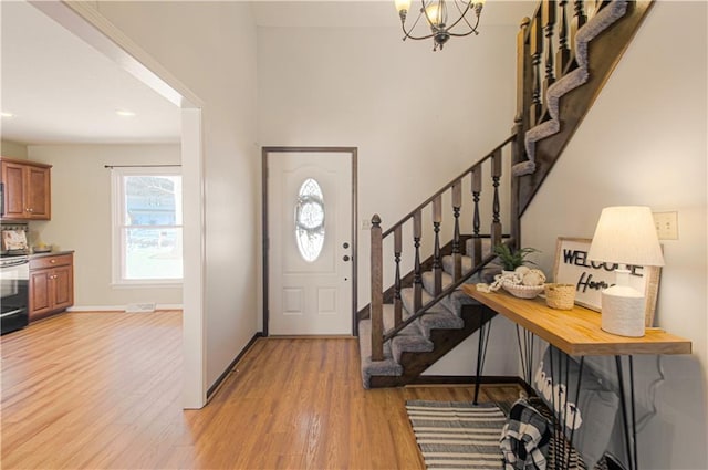 entrance foyer featuring an inviting chandelier and hardwood / wood-style floors