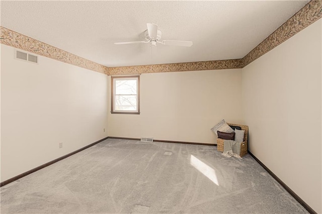 empty room with ceiling fan and carpet