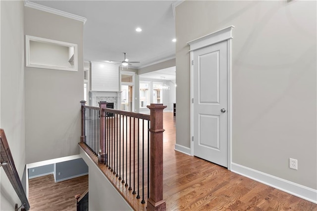 hallway with light hardwood / wood-style flooring and ornamental molding