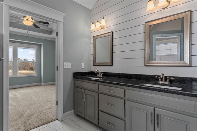 bathroom with ceiling fan, vanity, wood walls, and ornamental molding