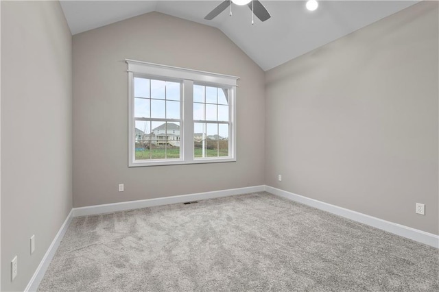 unfurnished room with ceiling fan, light colored carpet, and lofted ceiling