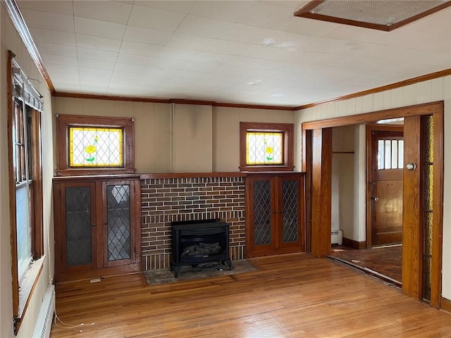 4512 Terrace St, Kansas City, MO 64111 - unfurnished living room featuring light wood-type flooring, ornamental molding, and a baseboard radiator