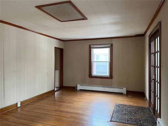 4512 Terrace St, Kansas City, MO 64111 - empty room featuring hardwood / wood-style floors, crown molding, and baseboard heating